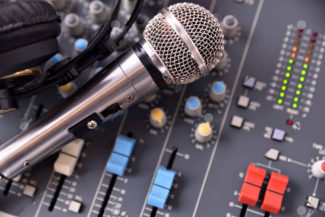 Recording equipment in studio. Studio microphone with headphones and mixer background. Top view